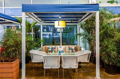 a gazebo with a table and chairs and plants at The Park Bangalore, MG Road in Bengaluru