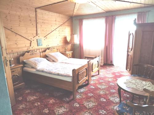 a bedroom with two beds in a wooden room at Pension Hubertushöhe in Kulmbach