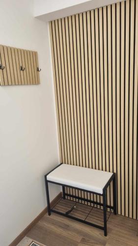 a bench sitting in a room with a wooden wall at apartment Sun Di Bohinj in Bohinj
