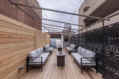 a row of couches on a wooden deck at Penthouse Grand Executive Suite in Louisville