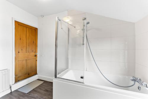 a bathroom with a shower with a glass door at Beautiful Gem of Chester - Sleeps 8 - Garden in Chester