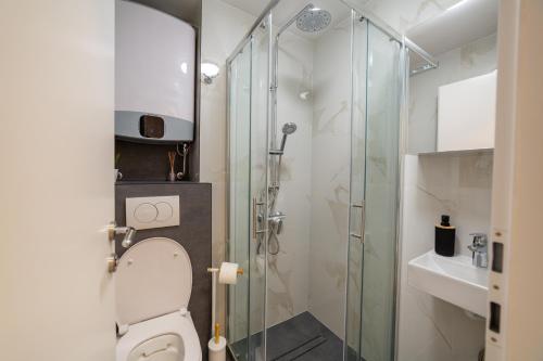 a bathroom with a toilet and a glass shower at Apartment Zvoncac in Split