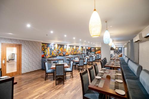 a dining room with tables and chairs in a restaurant at Hotel Seasons Inn in Nellore