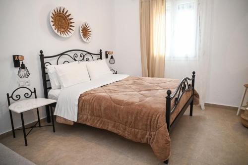 a bedroom with a large bed and a window at Gemilos Nest in Komia