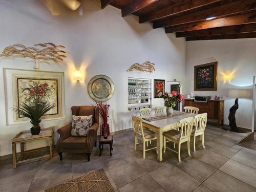 a kitchen and dining room with a table and chairs at Leopard Corner Lodge in St Lucia