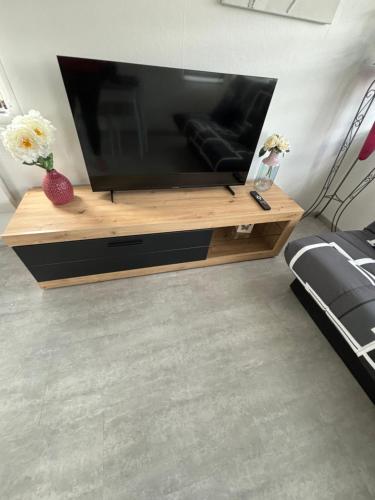 a living room with a large flat screen tv at Mobil-home camping 4 étoiles N35 in Fourmies