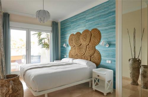 um quarto com uma cama grande e uma parede azul em Bogey by Oliva Nova em Oliva