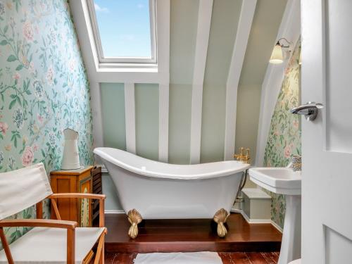 a bathroom with a tub and a sink at St Peters 