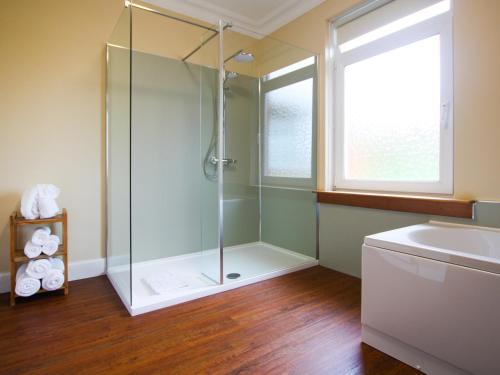 a bathroom with a shower and a sink at Cairncroft Cottage in Colfin