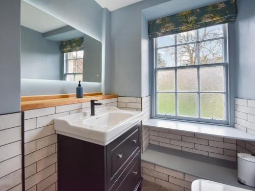 a bathroom with a sink and a window at Moncrieff House in Falkland
