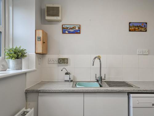 a kitchen with a sink and a counter top at Garden Cottage in Nafferton