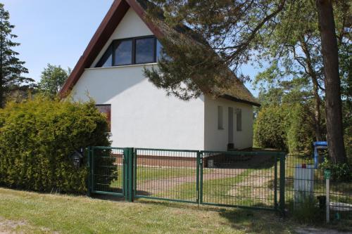 a house with a fence in front of it at "Fewo-Ulla- 1" Ferienwohnung im EG in Dierhagen