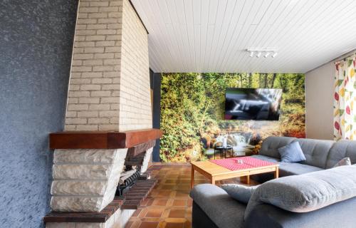 a living room with a couch and a fireplace at Ferienwohnung Wäller Mittagsonne in Westerburg