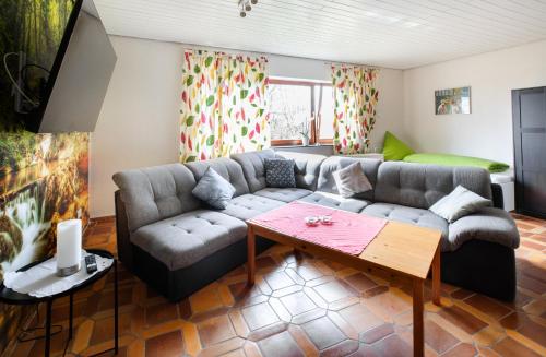 a living room with a couch and a table at Ferienwohnung Wäller Mittagsonne in Westerburg