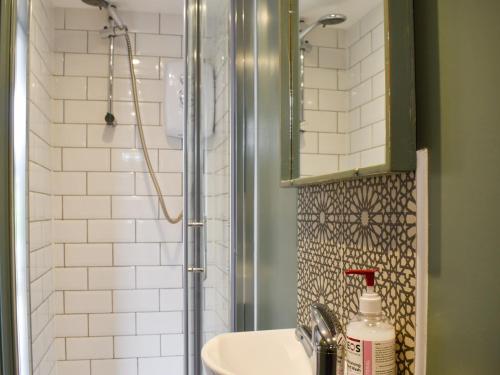 La salle de bains est pourvue d'un lavabo et d'une douche. dans l'établissement Shangri-la De Dah, à Margate