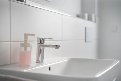 a bathroom sink with a soap dispenser on it at Schöne Apartments in Lengerich I home2share in Lengerich