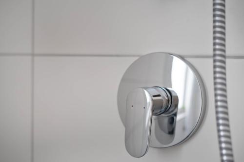 a mirror on a wall in a bathroom at Schöne Apartments in Lengerich I home2share in Lengerich
