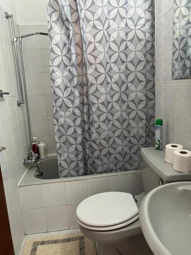 a bathroom with a shower with a toilet and a sink at Maresea rooms in Larnaka