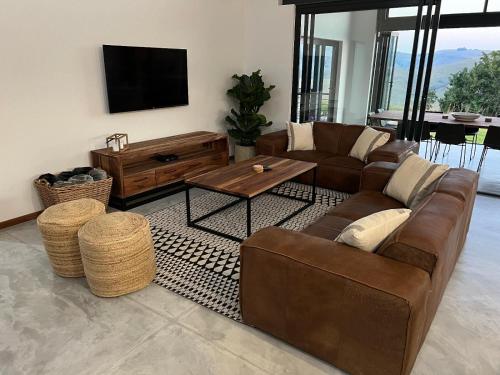a living room with a couch and a coffee table at Bald Ibis (856 Highland Gate) in Dullstroom
