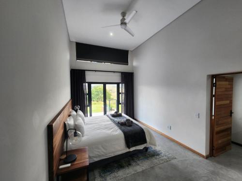 a bedroom with a bed and a ceiling fan at Bald Ibis (856 Highland Gate) in Dullstroom