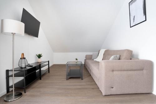 a living room with a couch and a table at Schöne Apartments in Lengerich I home2share in Lengerich