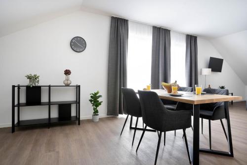 a dining room with a table and chairs at Schöne Apartments in Lengerich I home2share in Lengerich