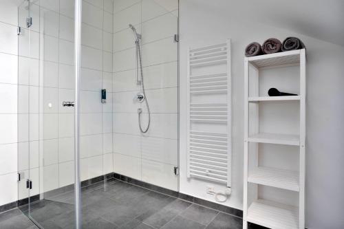 a bathroom with a shower and a glass shower stall at Schöne Apartments in Lengerich I home2share in Lengerich