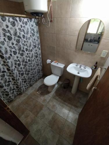 a bathroom with a toilet and a sink at Cabañas Cerro Tolosa in Uspallata
