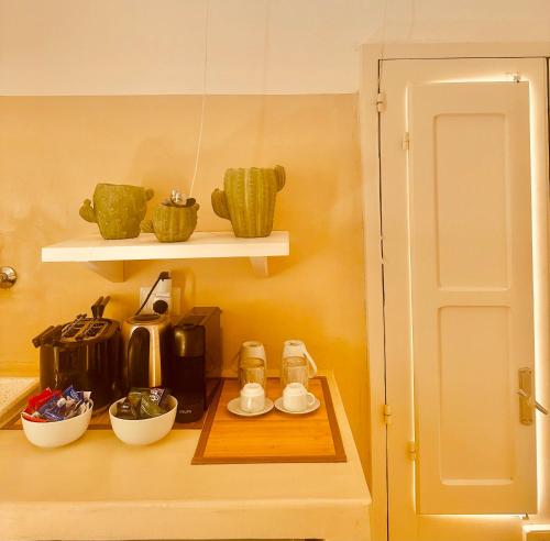 a kitchen with a shelf with a coffee maker on a table at Palazzo Boccaccio in Matino