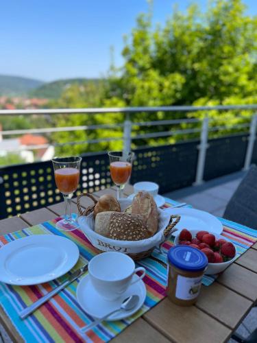a table with a plate of food and glasses of wine at Ferienhaus Chalet Andante in Hannoversch Münden