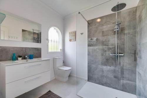 a bathroom with a shower and a toilet and a sink at Casa Panoramica in Mijas