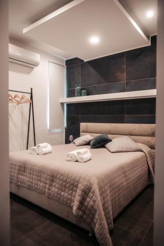 a bedroom with a bed with towels on it at B&BIO SPA in Catanzaro