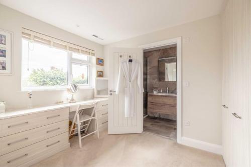 a white bathroom with a sink and a mirror at Windsor Charm Spacious 3-Bed, Parking & Garden - By Tempstay in Windsor