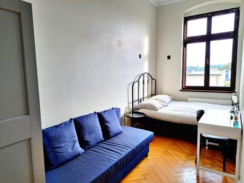 a living room with a couch and a bed at Kopernik Premium Rooms Apartment in Toruń