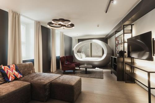 a living room with a couch and a large mirror at Hotel Klaus K in Helsinki