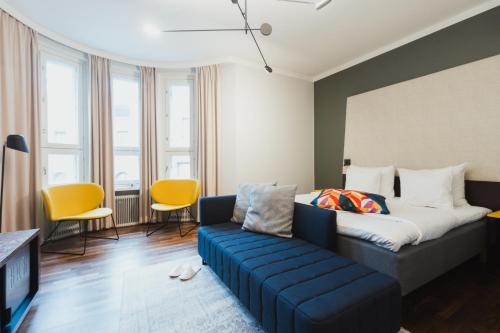 a living room with a bed and a couch at Hotel Klaus K in Helsinki