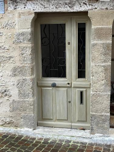 a door with a window on a stone building at LA SIESTE in Cahors