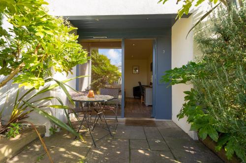 a patio with a table and chairs next to a house at The Red Lion at Stiffkey in Stiffkey