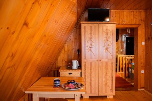 a wooden room with a table and a cabinet at Willa Pod Jesionami in Zakopane