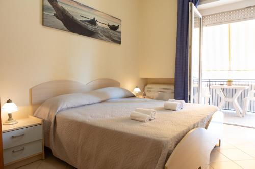 a bedroom with a bed with two towels on it at Affittacamere Piazza Mazzini in Terracina