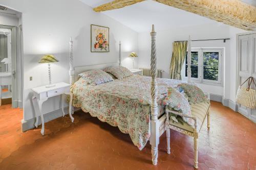 a white bedroom with a bed and a chair at Château Mentone in Masseboeuf