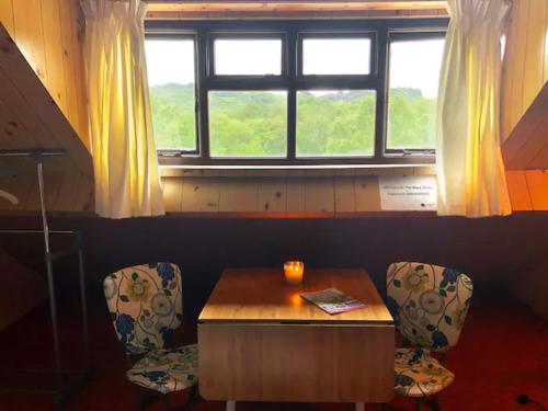 a room with a table and two chairs and a window at The Black Sheep in Glengarriff