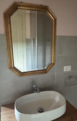 a bathroom with a bath tub with a mirror at Monte Cuccolo House B&B in Fontanelice