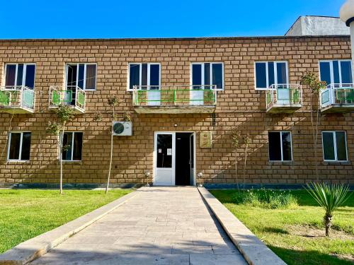 a brick building with a white door at Ayg Hotel and Sport Complex Ararat in Davalinskiy Tsemzavod