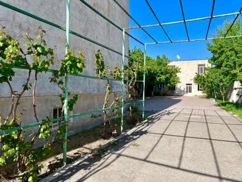 a fence in front of a building with trees at Ayg Hotel and Sport Complex Ararat in Davalinskiy Tsemzavod