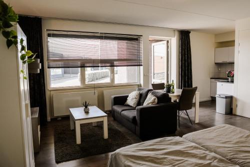 a living room with a couch and a table at Strand Appartementen Wemeldinge in Wemeldinge
