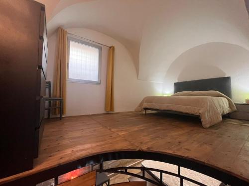 a bedroom with a bed and a window at La Nuotatrice in Lecce