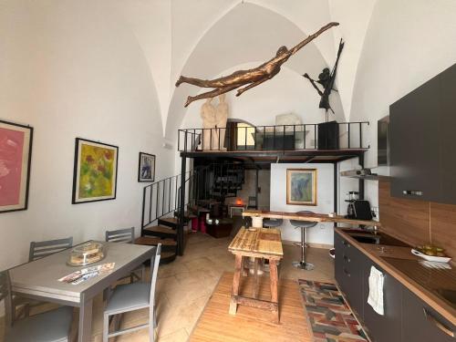 a living room with a spiral staircase and a table at La Nuotatrice in Lecce