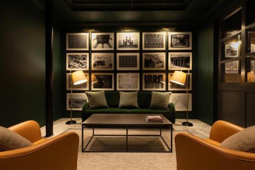 a living room with a green couch and two chairs at Hotel Indigo - Dundee by IHG in Dundee