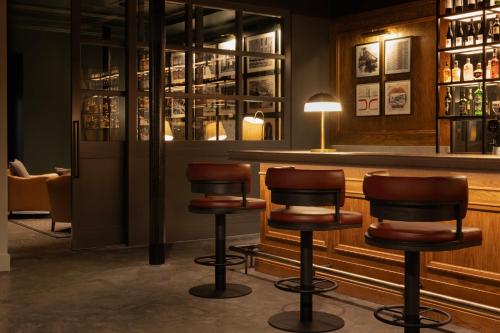 a bar with two chairs and a counter at Hotel Indigo - Dundee by IHG in Dundee